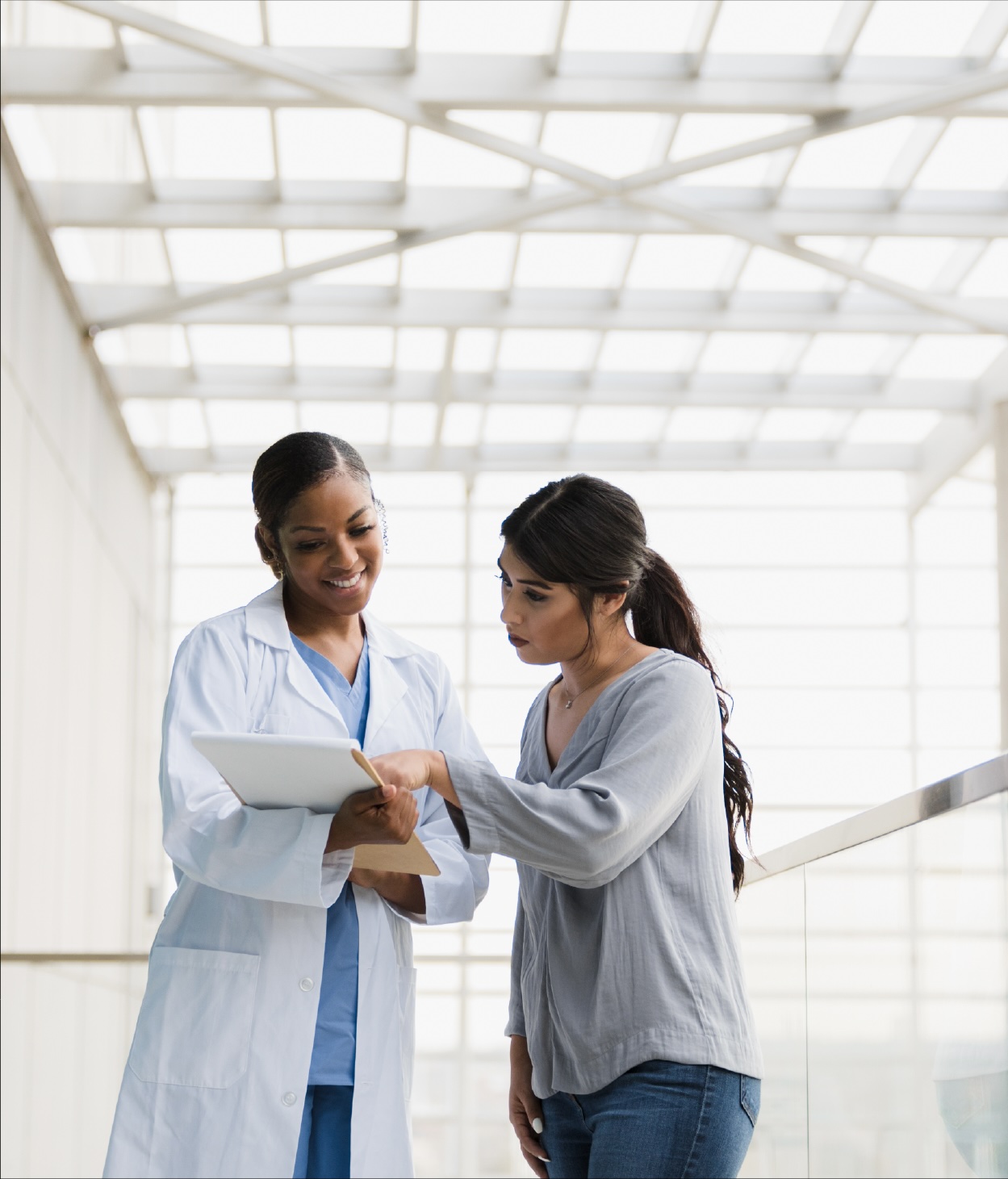 A doctor showing her notes to her patient.