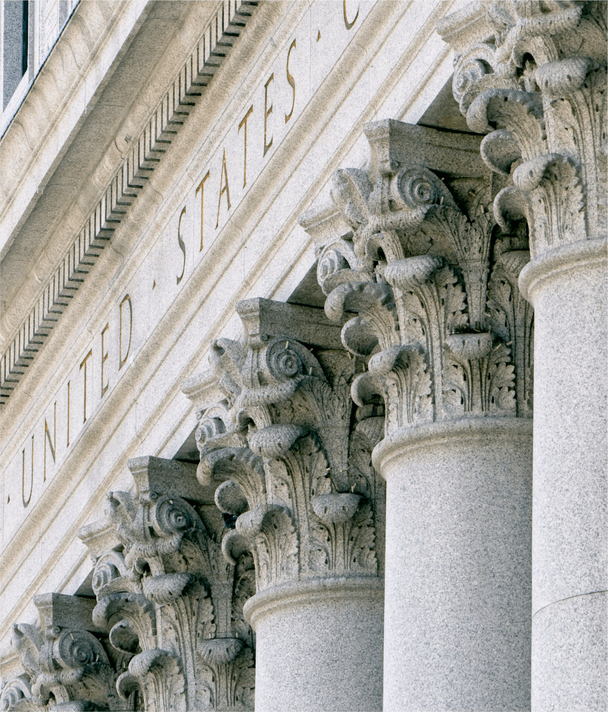 photo of a close-up shot of stone classical columns on a United States federal government building.